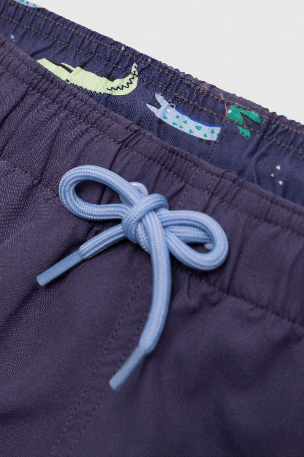 Boy's short swimming trunks with contrasting navy lining