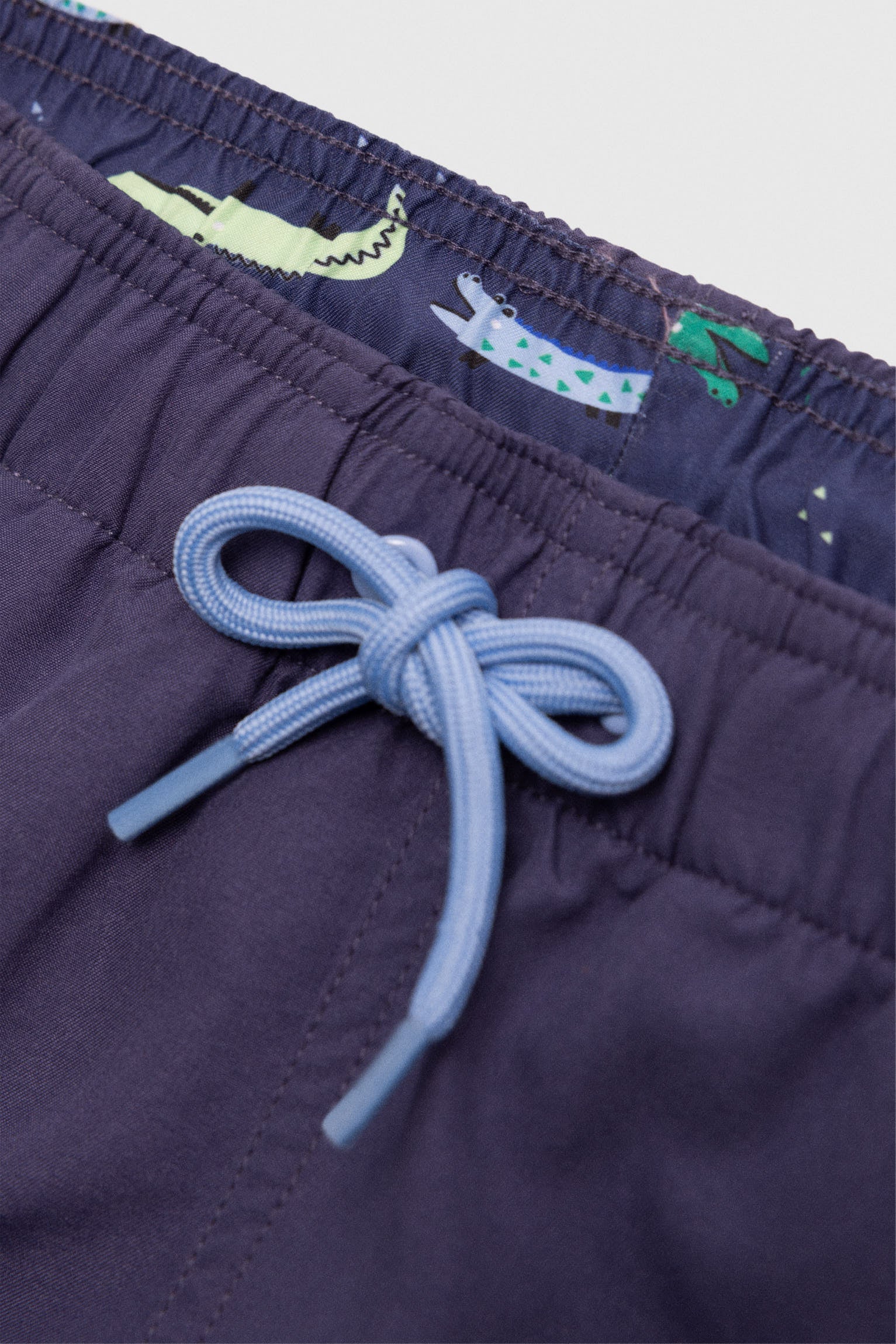 Boy's short swimming trunks with contrasting navy lining