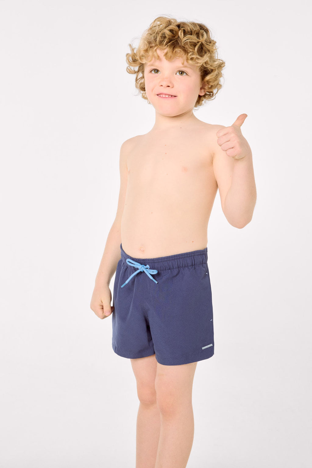 Boy's short swimming trunks with contrasting navy lining